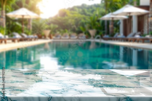 Empty white marble stone table top and blurred swimming pool in tropical resort in summer banner background - can used for display or montage your products. 