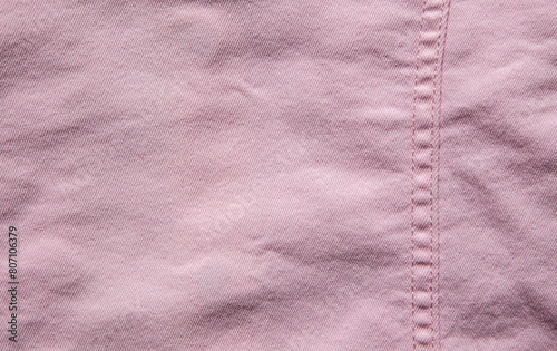 texture of pink jeans denim fabric with seam background