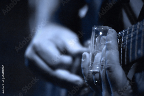 Tight Closeup of Guitarist Using a Slide