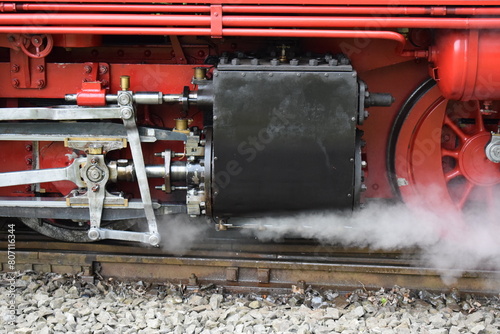 old steam train engine while running photo