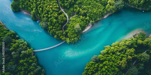 An aerial shot that showcases the beauty of a forested island split by turquoise waters and connected by bridges