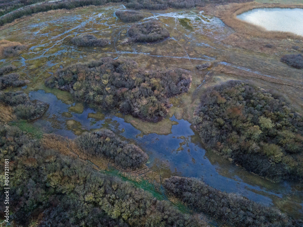 Aerial top down of wetlands at IJmuiden beach at sunset by North Sea in North Holland