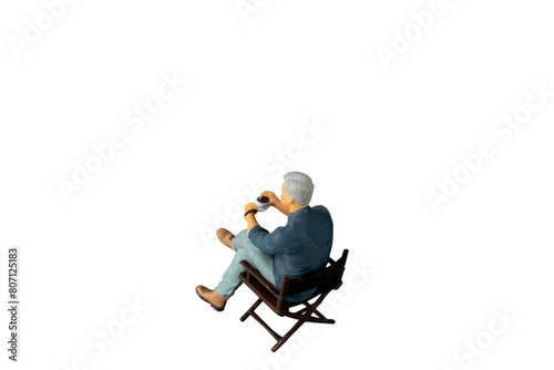 A businessman seated on a chair and sipping hot coffee isolated on white background with clipping path