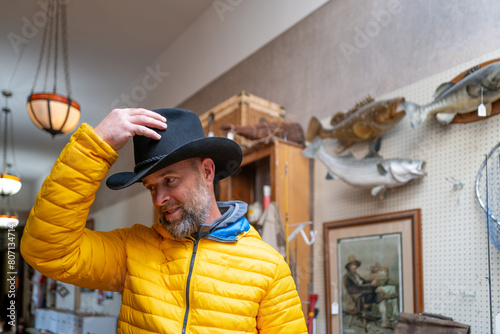 Man wearing cowboy hat at the thrift shop