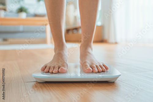 Woman Feet Standing Weighing Scales, Female Checking BMI Weight Loss. Barefoot Measuring Body Fat Overweight
