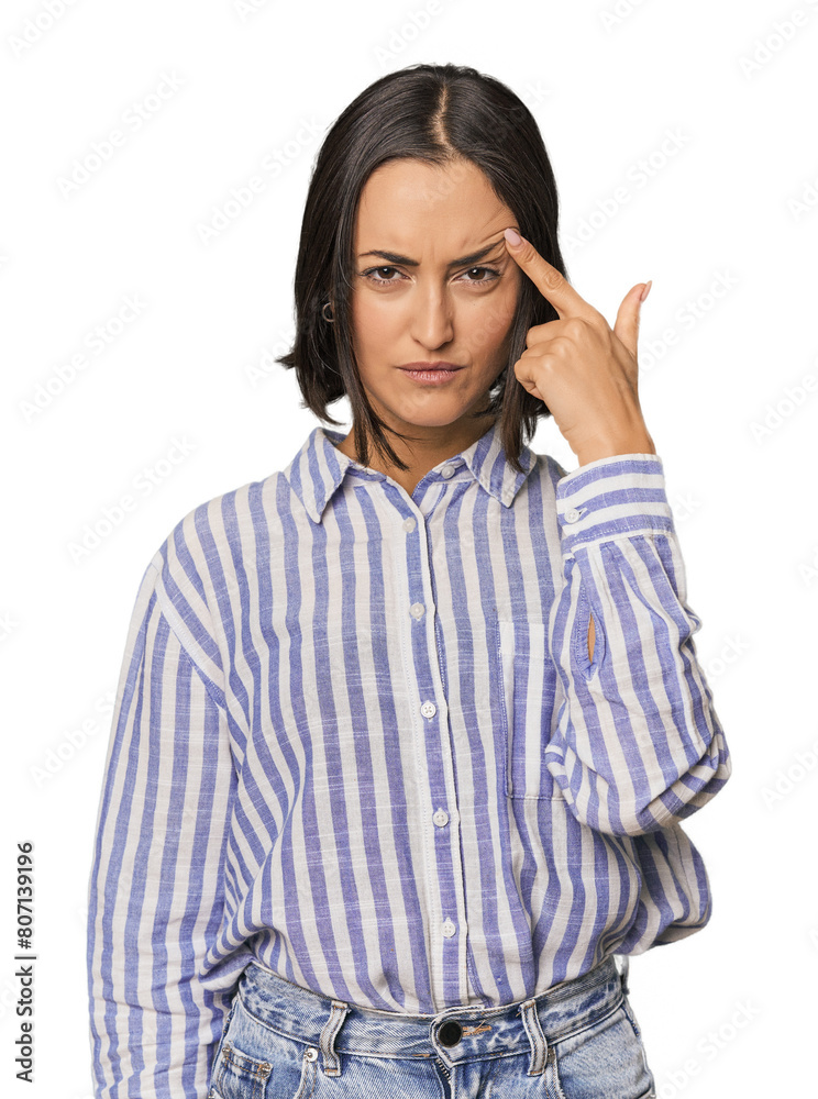 Young Caucasian woman with short hair pointing temple with finger, thinking, focused on a task. Young Caucasian woman with short hair pointing temple with finger, thinking, focused on a task.