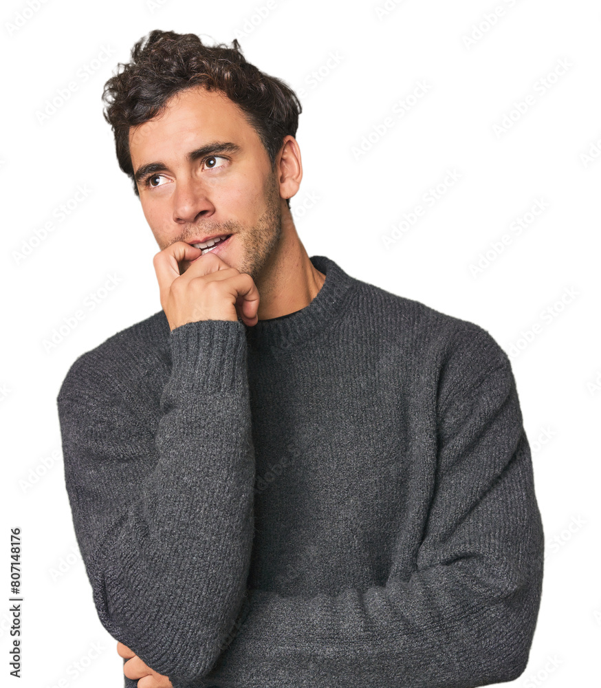 Young Hispanic man in studio relaxed thinking about something looking at a copy space. Young Hispanic man in studio relaxed thinking about something looking at a copy space.