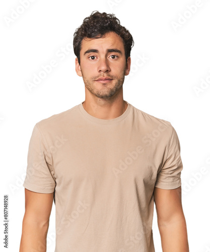 Young Hispanic man in studio sad, serious face, feeling miserable and displeased. photo