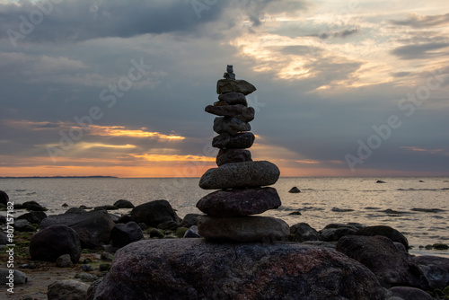 Stacked stones on a coast at sunset
