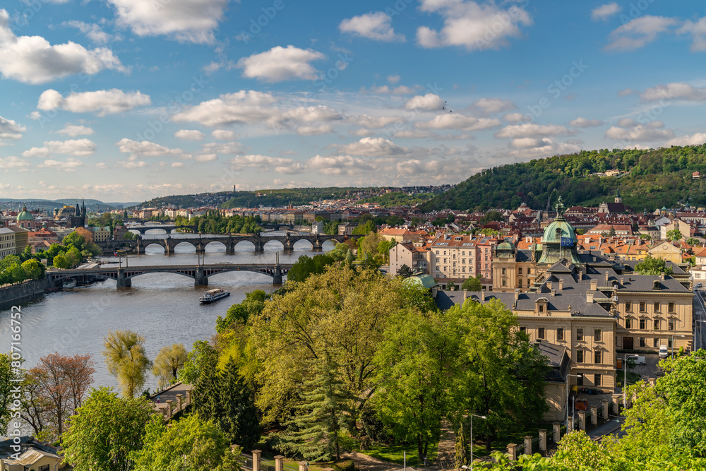Obraz premium Old town of Prague. Czech Republic over river Vltava with Charles Bridge on skyline. Prague panorama landscape view with red roofs. Prague view from Letna Park, Prague, Czechia.