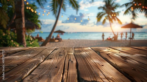 A deserted wooden table with a blurred beach party in the background, creating a picturesque setting for social events.
