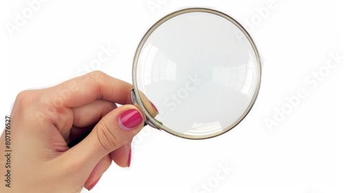 An isolated white background shows a female hand holding a magnifying glass.