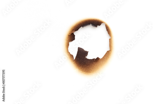 Hole in the burned paper isolated on white background