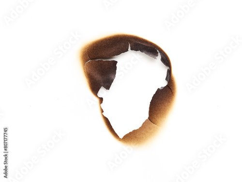 Hole in the burned paper isolated on white background