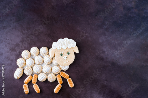 Semolina cookies maamoul arranged in shape of sheep. Traditional arabic holiday sweets. Eid al Adha concept background
