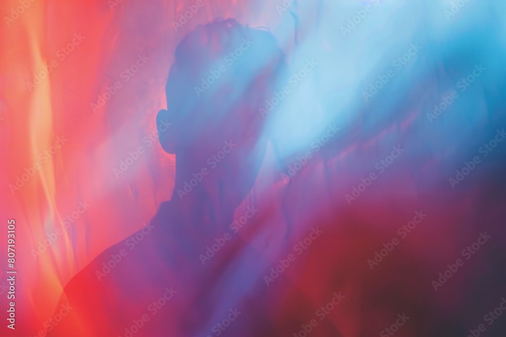 Silhouette of a man in a red and blue smoke