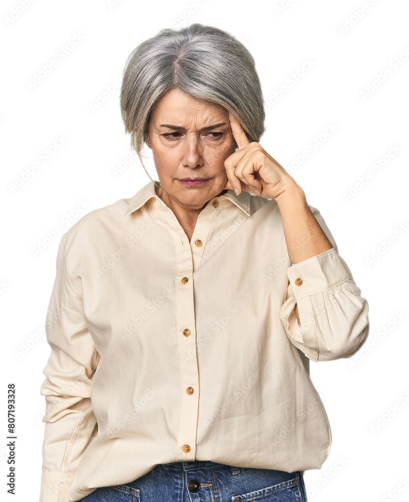 Caucasian mid-age female on studio background pointing temple with finger, thinking, focused on a task. Caucasian mid-age female on studio background pointing temple with finger, thinking, focused on a task.