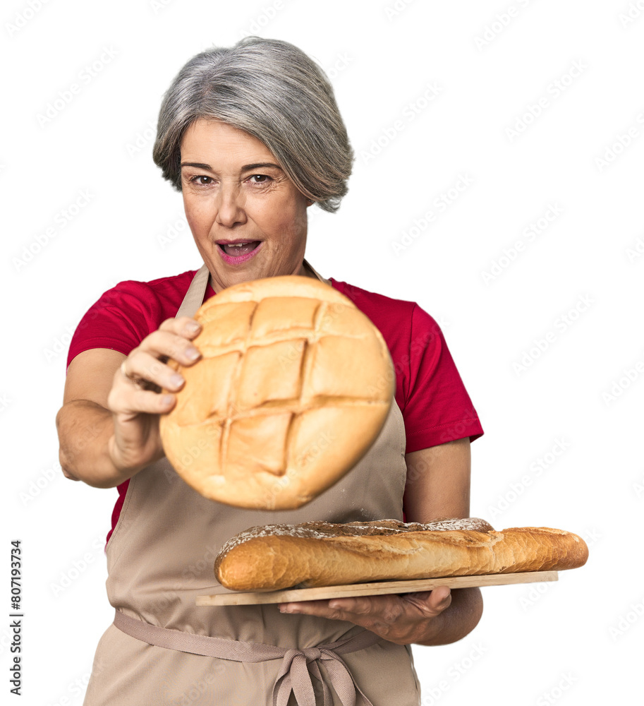 Middle-aged Caucasian female baker with bread tray Middle-aged Caucasian female baker with bread tray