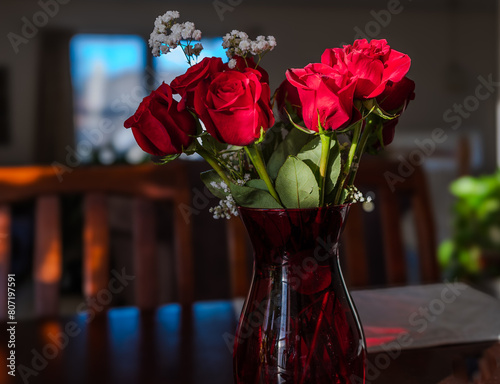 sunlit bouquet of roses in a vase