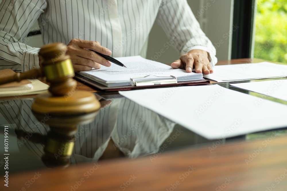Judge gavel with Justice lawyers having team meeting at law firm background. Concepts of Law and Legal services. Judge gavel with Justice lawyers having team meeting at law firm background. Concepts of Law and Legal services.