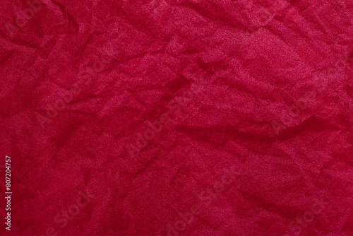 Background with crumpled, battered, red fabric material with copy space.Empty blank backdrop