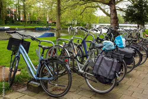 Bicycles parked in a row in a park in Amsterdam, Netherlands.