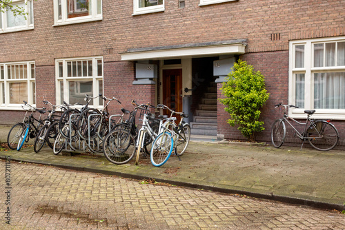 Photography Bicycles parked in a row in front of a house in Amsterdam, Netherlands