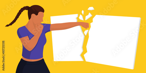Confident woman breaking a sign with a fist