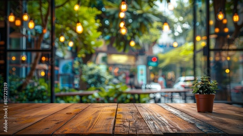 A Potted Plant on a Wooden Table with blur restaurant background.