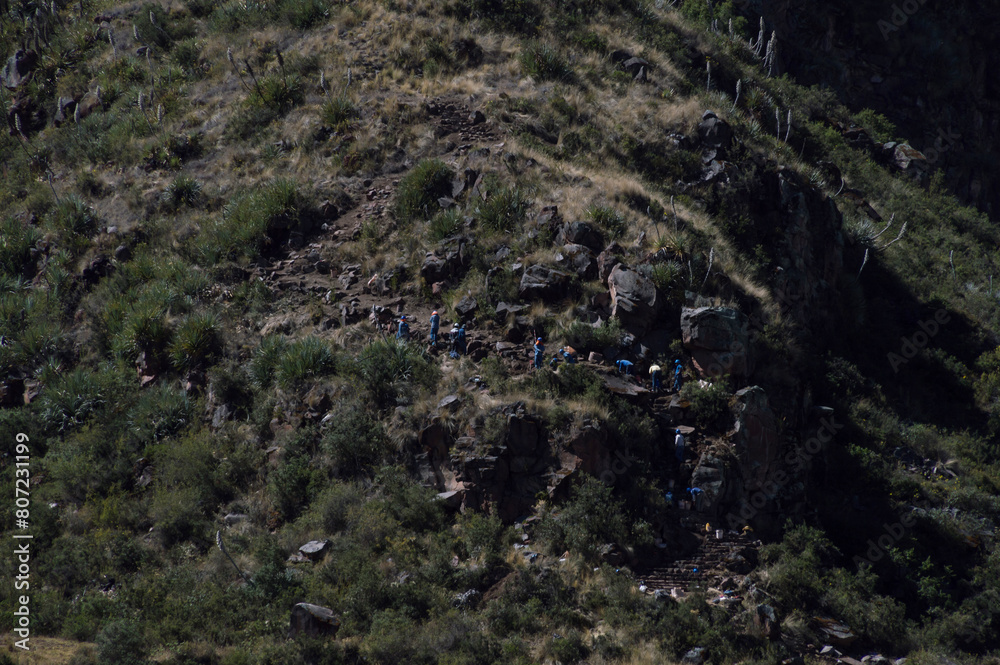 Workers working on rebuilding a stone staircase on a mountain path at the archaeological site of Típon Workers working on rebuilding a stone staircase on a mountain path at the archaeological site of Típon