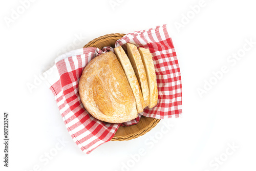 Fresh slice of bread in basket with napkin on a white background for breakfast.