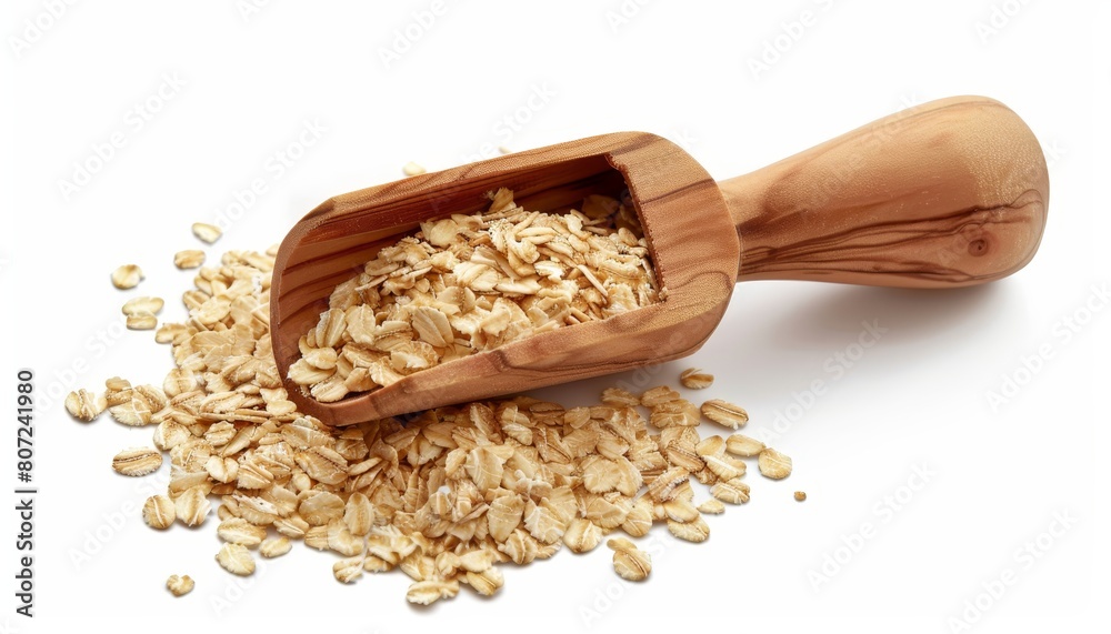Rolled oats in wooden scoop isolated on white background for packaging design Rolled oats in wooden scoop isolated on white background for packaging design