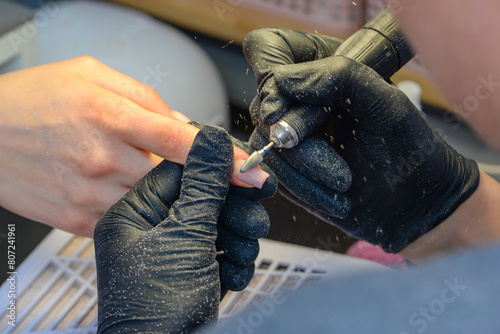 Close-up manicure process, female hands painting nails