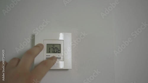 Hand regulates heating temperature at home