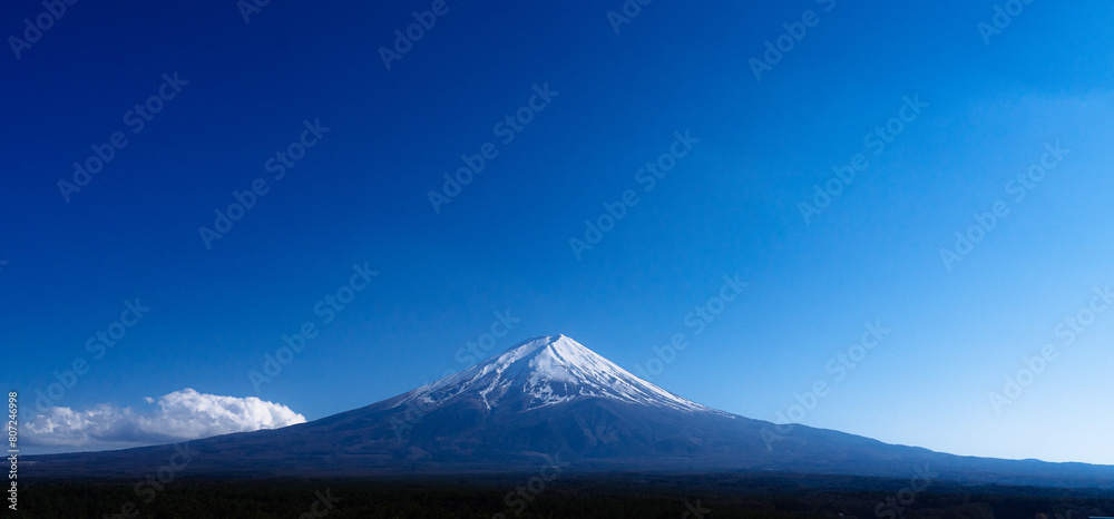 A cloudless sky stretching for miles, alongside the majestic Mount Fuji, a landmark of Japan.
