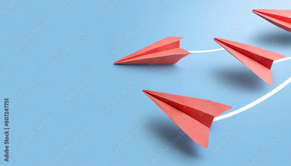 Three red paper airplanes on a light blue background, arranged in a diagonal formation with a curving trail. Three red paper airplanes on a light blue background, arranged in a diagonal formation with a curving trail.