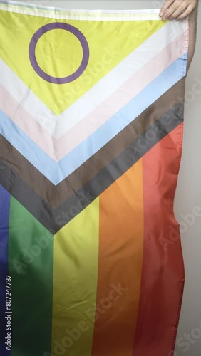 lgbtq+ pride 2024 concept.Person waving  New lgbt flag