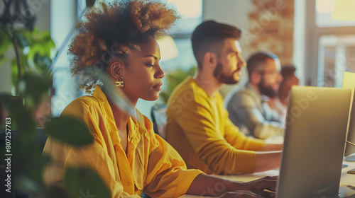 Dynamic Collaboration: Colleagues Working Together at a Desk in a Modern Office Setting