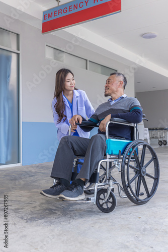 Doctor or Caregiver nurse take care a Senior patient sit on wheelchair. Doctor or Nurse helping senior Man