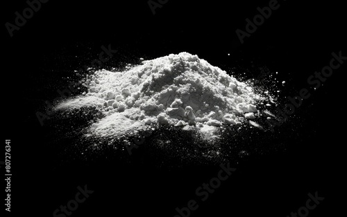 A pile of fine white powder isolated on a black background.