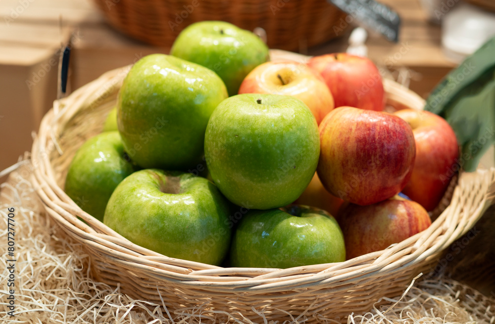 Basket of assorted apples on display for sale at the market Basket of assorted apples on display for sale at the market