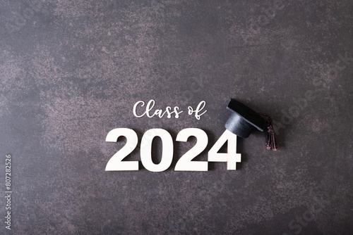 Wooden number 2024 with graduated cap. Class of 2024 concept.
