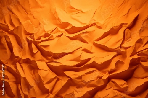 Orange crumpled paper texture used for paper background texture in decorative art work. Orange silk crumpled fabric as an abstract background. Wallpaper background
