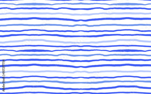 Hand drawn blue wavy lines on white background. Structure stroke seamless pattern. Summer stripes concept for design, textile, and wallpaper. Marine life and seaside decor. 
