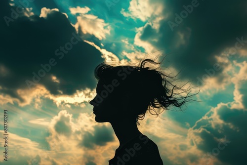 Close up of woman standing while looking at twilight sky and cloud with silhouette filter. Young beautiful girl looking for far away with sky. Represented feminist, equality, freedom, strength. AIG42.