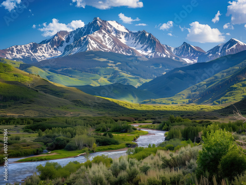 The breathtaking mountain scenery features snow-capped peaks, lush valleys, and a tranquil river. The vibrant colors and rich textures offer a stunning backdrop for relaxation and adventure.