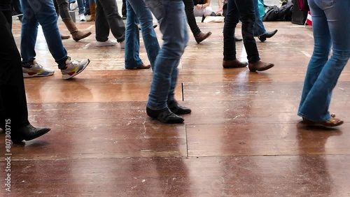 People dance with cowboy boots to typical American culture such as the Texan one. Group dances in company for fun. Quadrille conceptual Legs close up of tradition western folk  photo