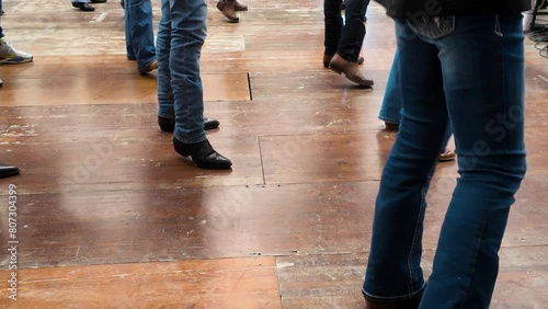 People dance with cowboy boots to typical American culture such as the Texan one. Group dances in company for fun. Quadrille conceptual Legs close up of tradition western folk 