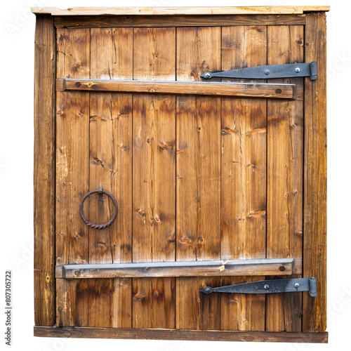 an antique wooden barn door with massive iron hinges and an iron round handle.