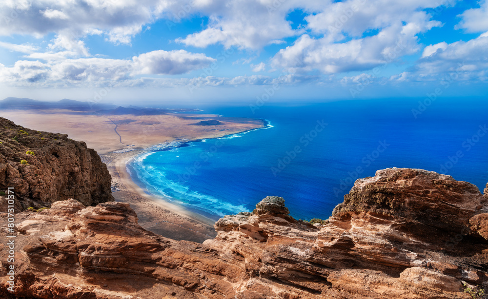 Aerial view of Playa Famara - view from Acantilados de Famara, Mirador del Risco de Famara - National park El Bosquecillo, Haria in Lanzarote